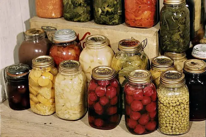 Lots of canned vegetables in Ball glass jars. 