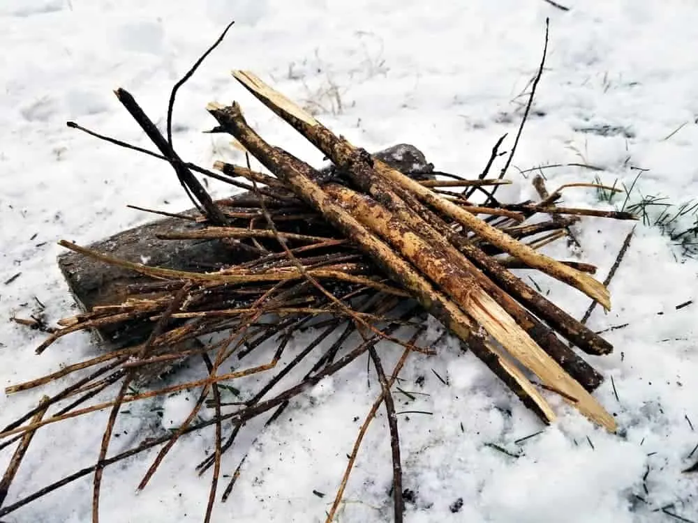 Discover How To Build A Campfire With Minimal Gear In Every Situation 5 The Lean-to style of campfire is ideal for severe weather.