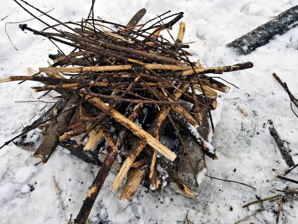 The Pyramid or Upside Down Campfire is an excellent option if you can't find dry fuel. The fire on top will dry out the damp wood below until it is dry enough to catch.