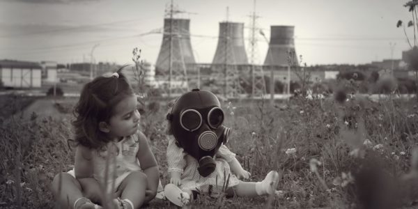 Little girl sitting with a baby doll