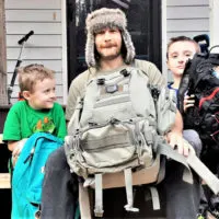 dad and sons with bug out bags