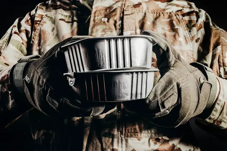 Soldier holding two MRE meals