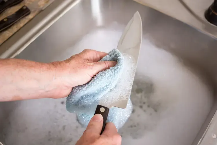Washing knife with warm water