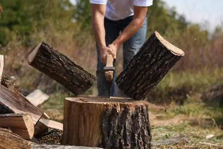 using axe for firewood chopping