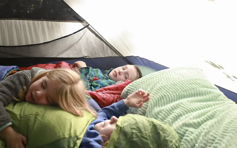 kids sleeping in a camping tent